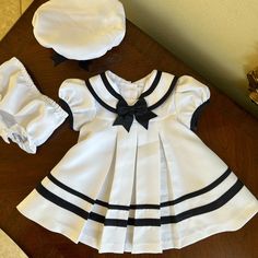 Nwot Rare Editions Dress Is A White And Navy Blue Color, With Matching Hat And Panties. Classic Cuteness In New Condition! See Close Up Picture For Colors And Details Fitted Sailor Dress With Short Sleeves, Sailor Style Short Sleeve Fitted Dress, White Sailor Dresses For Spring, White Sailor Cotton Dress, Sailor Style White Cotton Dress, White Sailor Style Dress For Spring, White Cotton Sailor Dress, White Sailor Style Spring Dress, Fitted Lined Dresses For Playtime