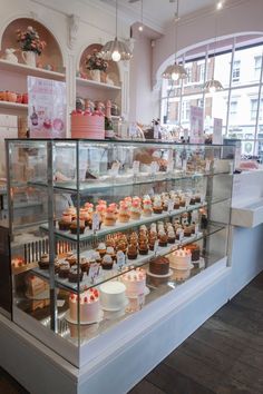 a bakery filled with lots of cakes and cupcakes