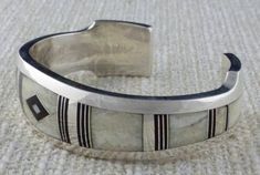 Luxury Silver Jewelry With Inlay, White Engraved Bracelets For Weddings, Luxury White Bracelets With Polished Finish, Luxury White Sterling Silver Bangle Bracelet, Luxury White Sterling Silver Adjustable Bracelet, Artisan White Cuff Bracelet As Gift, Artisan White Cuff Bracelet Gift, Luxury Adjustable White Sterling Silver Bracelet, Classic White Sterling Silver Bangle