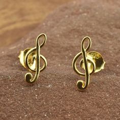 "Music note treble clef gold studs in Gold Vermeil. A perfect gift for the musician in your life, or to show your love of music. View matching necklace and gold and silver music notes here:- https://www.etsy.com/uk/shop/RoyalMileSilver?.=undefined&section_id=37605442 * Sold as a PAIR * A high quality, unique product * Pair Weight 0.8gr * Gift boxed * Ships direct from Edinburgh, Scotland * Supports a small artisan business \"Love music, Love Life !\" Vermeil is a technique originating in the 19th century, where gold is applied to sterling silver - making this a hypoallergenic product that can be worn without worry about the base metal being brass, copper or similar. We have created this to offer an affordable range of designs in gold and rose gold that can still be worn by those prone to s Personalized Gold Music-themed Jewelry, Music-themed Yellow Gold Jewelry Gift, Music Note Jewelry, Small Earrings Gold, Treble Clef, Music Note, Edinburgh Scotland, Love Music, Earrings In Gold