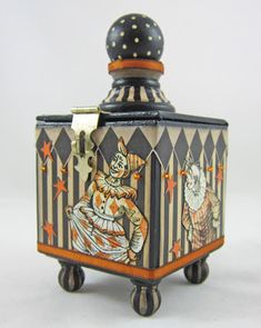 a small box with an image of a clown on it's lid and wheels