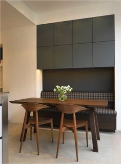 a wooden table with three chairs around it