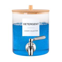 a blue container with a metal faucet and label on the lid that says detergent laundry collection