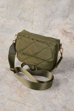 Great for travel or as an everyday accomplice, our Medina Soft Crossbody Bag in Khaki features elegant, quilted detailing at the front and a comfortable guitar strap. Storage includes a main zip compartment and outer slip pocket. Your next adventure awaits! Functional Quilted Shoulder Bag For On-the-go, Functional Quilted Crossbody Bag, Quilted Crossbody Bag For On-the-go, Quilted Crossbody Satchel For Everyday Use, Quilted Travel Crossbody Bag, Quilted Crossbody Travel Bag, Quilted Rectangular Bag For Weekend Trips, Quilted Crossbody Shoulder Bag For Everyday Use, Quilted Nylon Crossbody Bag