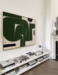 a living room filled with furniture and a painting on the wall over a fire place