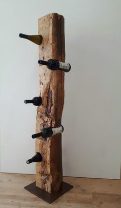 a wooden wine rack with six bottles on it