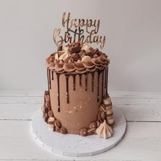 a birthday cake with chocolate icing and decorations