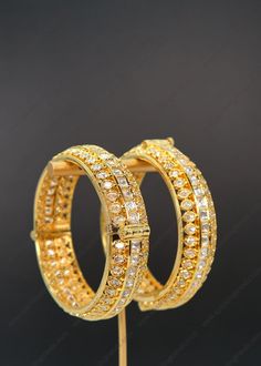 "Premium Quality Tyaani Kundan Openable Kada. You can Pair this with your stunning saree look or with any Ethnic outfit. Openable Kada - You can go one size up or down. Size: 2.4 ( Diameter 5.8)  Width: Approx. 1/2\" Screw Opening Comes 2 in a set 1 Gram Gold plated on high-quality brass as the base metal. *Color may vary slightly due to light condition & photography. Jewelry Care:  Keep away from moisture. Allow perfumes and lotion to dry before wearing. Store in jewelry pouch. Clean only with soft lint-free cloth." Heavy Bollywood Style Saree, Heavy Traditional Saree For Festivals, Heavy Bollywood Saree, Heavy Bollywood Dupatta For Diwali, Heavy Bollywood Traditional Wear For Festive Season, Traditional Heavy Sharara For Festivals, Bollywood Style Heavy Traditional Wear For Festive Season, Heavy Traditional Wear For Festive Occasions, Festive Bollywood Heavy Traditional Wear