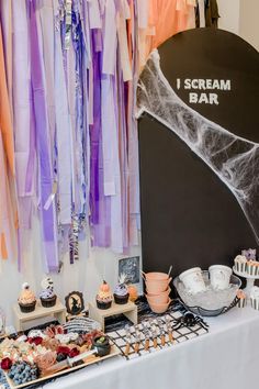 the dessert table is set up with cupcakes, cakes and other treats on it