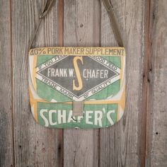 an old schafer's sign hanging on a wooden fence with the name frank w chafer