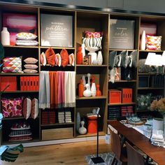 a room filled with lots of different types of clothing and accessories on shelving units