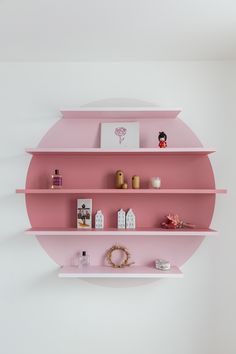 pink shelves with pictures and decorations on them