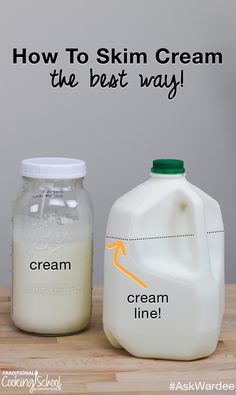 two jugs of cream sitting next to each other on top of a wooden table