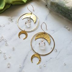 Hammered brass hoops and Moons featuring delicate Diamond Quartz Beads Simple and solid enough for daily wear 2" diameter. 3" long Each stone is unique and may vary slightly in color/shape from stone to stone. One of a kind handle with care Made with love by Elizabeth Cline in San Francisco, CA Wrapped in Dreamers of Dreams travel/gift bag Brass Moon Charm Jewelry For Festivals, Handmade Brass Half Moon Jewelry, Festival Moon-shaped Brass Jewelry, Festival Moon Shaped Brass Jewelry, Bohemian Moon Phase Jewelry For Everyday, Bohemian Moon Shaped Brass Jewelry, Bohemian Crescent Hammered Jewelry, Everyday Bohemian Moon Phase Jewelry, Festival Brass Jewelry With Moon Phase