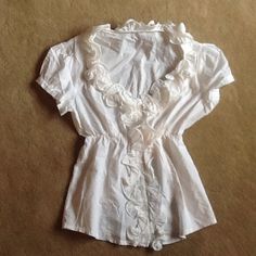 White cotton ruffle blouse. Gorgeous little number. Just too small for me.  Banded buttoned sleeves.  Ruffles around collar and down front.  Buttons down front. Never worn. Excellent condition. Extra small or small. Tops Blouses Feminine Ruffled Tops, Vintage Ruffle Blouse For Day Out, Vintage Ruffled Blouse For Day Out, Ruffle Collar Blouse, Ruffle Collar, Collar Blouse, White Blouse, Small Tops, White Cotton