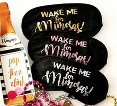 three personalized makeup pouches and a bottle of champagne