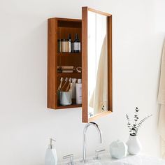 a bathroom sink with a medicine cabinet above it