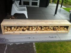 a bench made out of firewood sitting on top of a patio