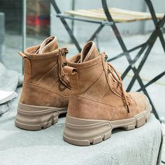 a pair of brown boots sitting on top of a table