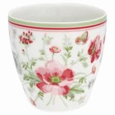 a white cup with red flowers and butterflies on it