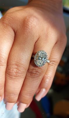 a woman's hand with a diamond ring on it