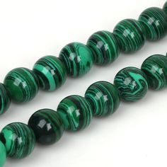 two strands of green and black glass beads