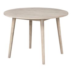 a round table with wooden legs and a white top, on a white background in front of a white backdrop