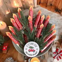 a christmas arrangement with candles and candy sticks