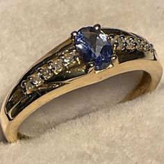 Tanzanite band with Diamond accents 14kt. yellow Gold Genuine .48 point Tanzanite 10 accent Diamonds 5 x 3, oval cut Size 7 Sophisticated Tanzanite Ring, Ring With Diamond, Oval Cut, Statement Rings, Diamonds, Size 7, Yellow Gold, Band, Ring