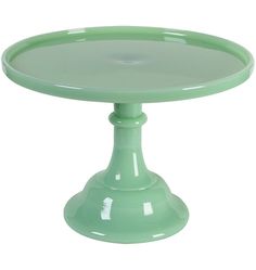 a green cake plate sitting on top of a white table