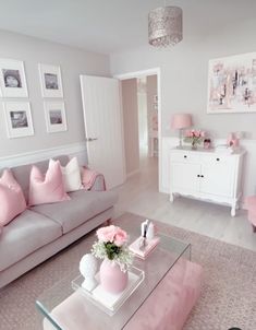 a living room filled with furniture and pink accents