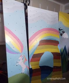 two painted boards with unicorns on them