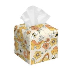 a tissue box with a bee and flower pattern on it