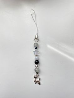 a necklace with beads and charms hanging from it