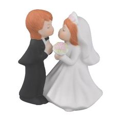 a figurine of a bride and groom sharing a kiss on their wedding day