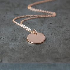 Feminine, lovely, simple, and sweet. A 14k rose gold filled circle disk is hung from a thin but sturdy gold filled chain. This is the necklace you will turn to everyday, to wear alone for a pretty accent, or to layer with other necklaces for the on-trend look. The disk measures 12mm (1/2 inch) in diameter. Choose your perfect necklace chain length from the drop-down menu. (The necklace shown on the model is 17 inches long.) Gold Disk Necklace, Gold Necklace Dainty, Disk Necklace, Gold Disc Necklace, Necklace Rose Gold, Gold Disc, Enamel Necklaces, Necklace Chain Lengths, Sterling Silver Chain Necklace