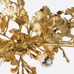 a gold chandelier with flowers and leaves on it