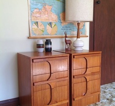 two wooden dressers sitting next to each other on top of a carpeted floor