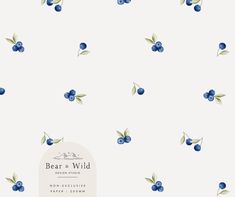 blueberries and leaves on a white background with the words bear & wild written below