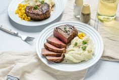 two plates with meat, mashed potatoes and corn