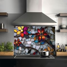 a stove top oven sitting inside of a kitchen next to a pot on a counter