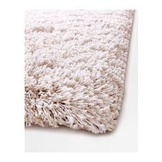 an area rug with white shag on the top and bottom part of it's surface