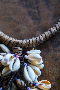 This African Tribal Cowrie Shell Necklace Pendant is a unique and timeless piece of jewelry crafted from an old Tribal Cowrie Shell pendant, leather necklace, and Venetian Chevron Trade Beads. Carefully handcrafted to last for years of enjoyment, it's a great way to show off your tribal culture in style. Length: 15 inches Bohemian Brown Ceremonial Jewelry, Ceremonial Handmade Adjustable Necklace, Unique Brown Jewelry For Ceremonial Occasions, Traditional Leather Jewelry For Festival, Artisan Adjustable Necklace For Ceremonial Use, Artisan Adjustable Necklace For Ceremonial Occasions, Artisan Adjustable Ceremonial Necklace, Artisan Brown Handwoven Necklace, Traditional Handmade Leather Jewelry