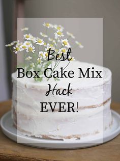 a white cake with daisies on top and the words best box cake mix hack ever