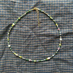 This necklace is handmade with care with a mix of gemstones and seed beads. I use both glass beads and genuine Pearls, Peridot, and Labradorite.  Each necklace is unique and varies due to the randomized pattern of the beads, but each will include the beads listed. Gemstones: Peridot, Pearl, Labradorite Length: 16" Green Czech Glass Spiritual Beads, Spiritual Green Czech Glass Beads, Green Spiritual Beaded Necklace With Spacer Beads, Spiritual Green Beaded Necklace With Spacer Beads, Festival Czech Glass Beaded Necklaces With Faceted Beads, Spiritual Green Beaded Necklaces With Small Beads, Czech Glass Beaded Necklace With Round Beads, Heishi Beaded Necklaces For Jewelry Making, Green Tiny Heishi Beads Necklaces