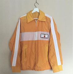 Vintage Retro Yellow Sportswear Jacket - White Stripes & Patch.Patch Says Glean Golden Prairie Project. Thin Fall Jacket. No Lining.Size: LargeBrand: Promo LTD. Teulon, Manitoba. Made in Canada.100% Nylon.✂ - - - - - m e a s u r e m e n t s: taken lying flat: Bust/Chest from Armpit to Armpit: 24 inches (48 inches doubled)Waist Area: 22.5 inches (45 inches doubled)Shoulder to Shoulder: openSleeve Length: 22 inchesLength from Shoulder to Bottom Hem: 27 inches Retro Yellow, Retro Jacket, Open Sleeve, White Jacket, Fall Jackets, Puma Jacket, White Stripe, Retro Vintage, Athletic Jacket