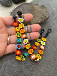 someone is holding some beaded bracelets in their hand and they are all made out of beads