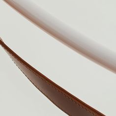 a pair of glasses sitting on top of a white table next to a brown leather case