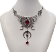 "This dramatic Triple Crescent Moon necklace features antique silver tone filigrees, crescent moons and a dainty bat, adorned with dazzling Ruby Red glass jewels. Decorated length portion is 6 1/4\" wide and 4\" tall in the very center (above oval stone to bottom teardrop). Necklace is adjustable in length. It is worn with soldered stainless steel cable chain and closes with a lobster clasp. If you would like a different length, please send us a message. Matching earrings are listed separately i Red Gothic Necklace, Vampire Necklace, Victorian Accessories, Triple Moon Goddess, Victorian Necklace, Armadura Medieval, Green Beaded Necklace, Vampire Bat, Gothic Victorian