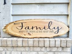 a wooden sign that says family where life begins and love never ends on the side of a building